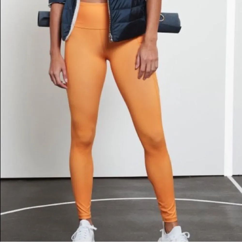 Athleta Salutation Stash Tights in Sunrise Orange